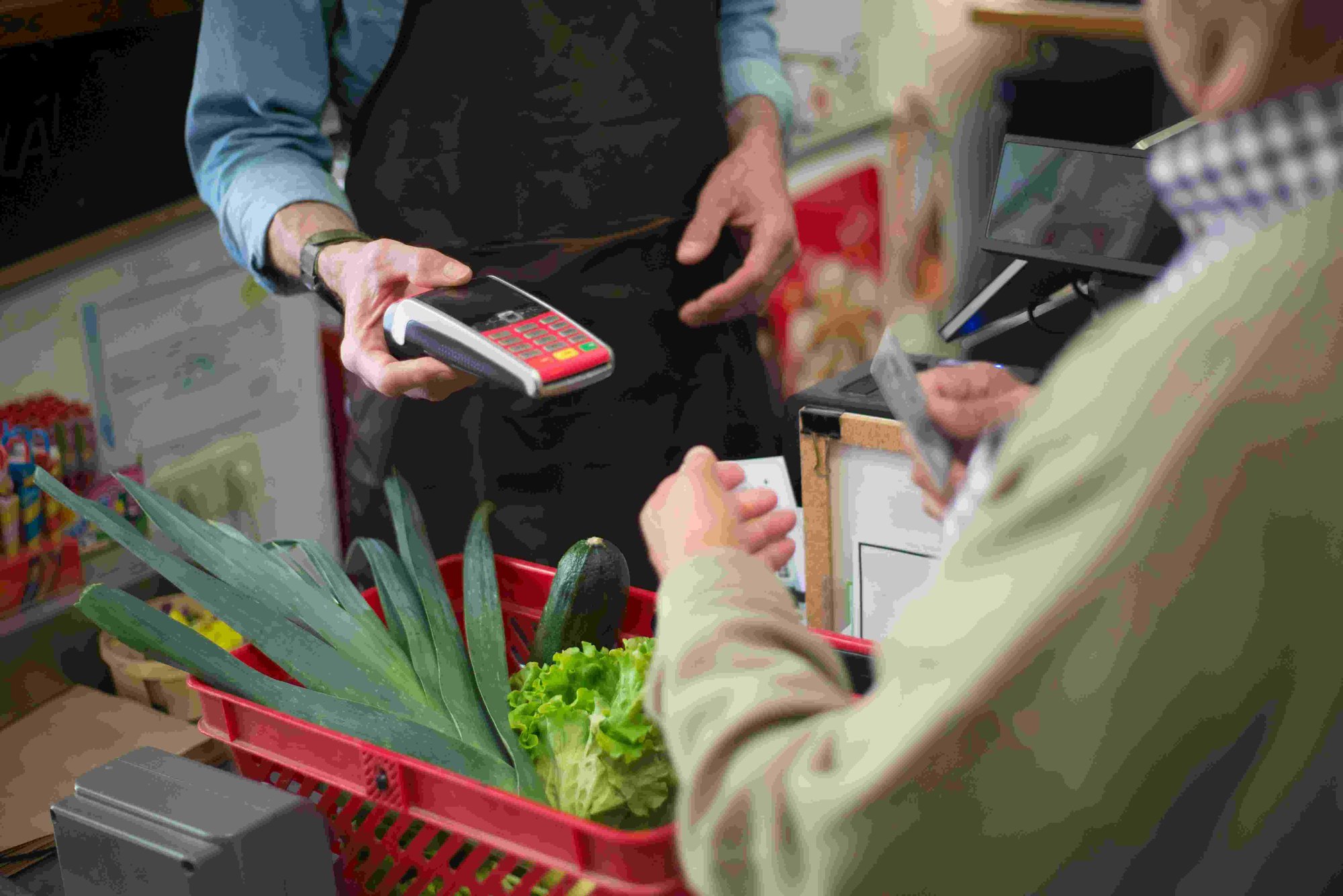 Person paying for groceries at checkout